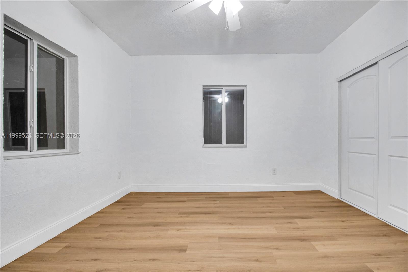 1925 Northwest 49th Street Miami, FL 33142 - Photo 25 of 30 a view of an empty room with wooden floor and a window