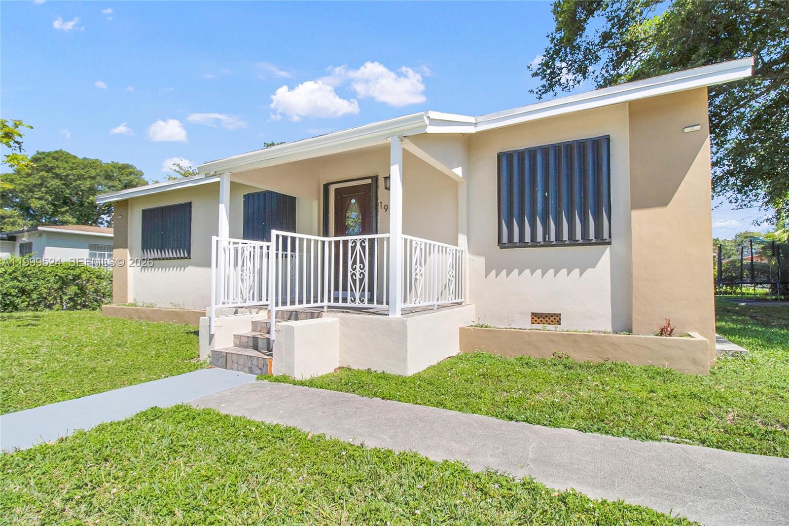 1925 Northwest 49th Street Miami, FL 33142 - Photo 4 of 30 a front view of a house with a yard