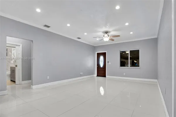 a kitchen with stainless steel appliances granite countertop a refrigerator sink and white cabinets