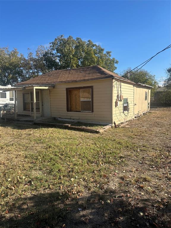 1015 South Pecos Street Coleman, TX 76834 - Photo 2 of 7 a house with trees in the background