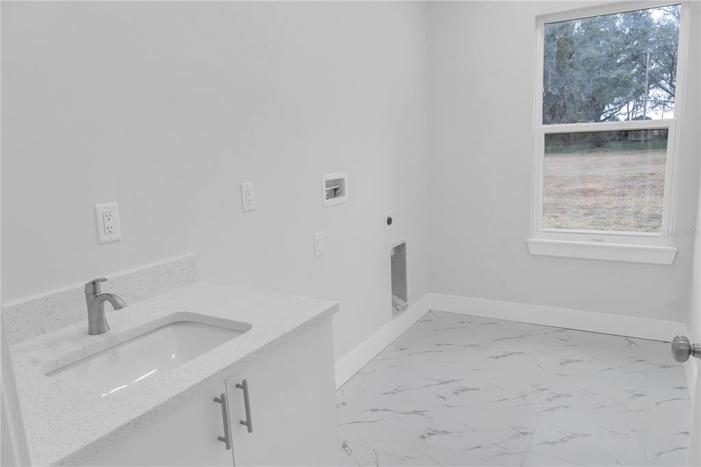 5530 Bell Street Zephyrhills, FL 33542 - Photo 11 of 16 a bathroom with a sink and a bathtub