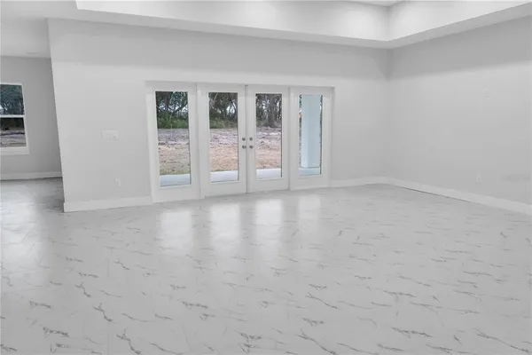 a view of an empty room with glass door