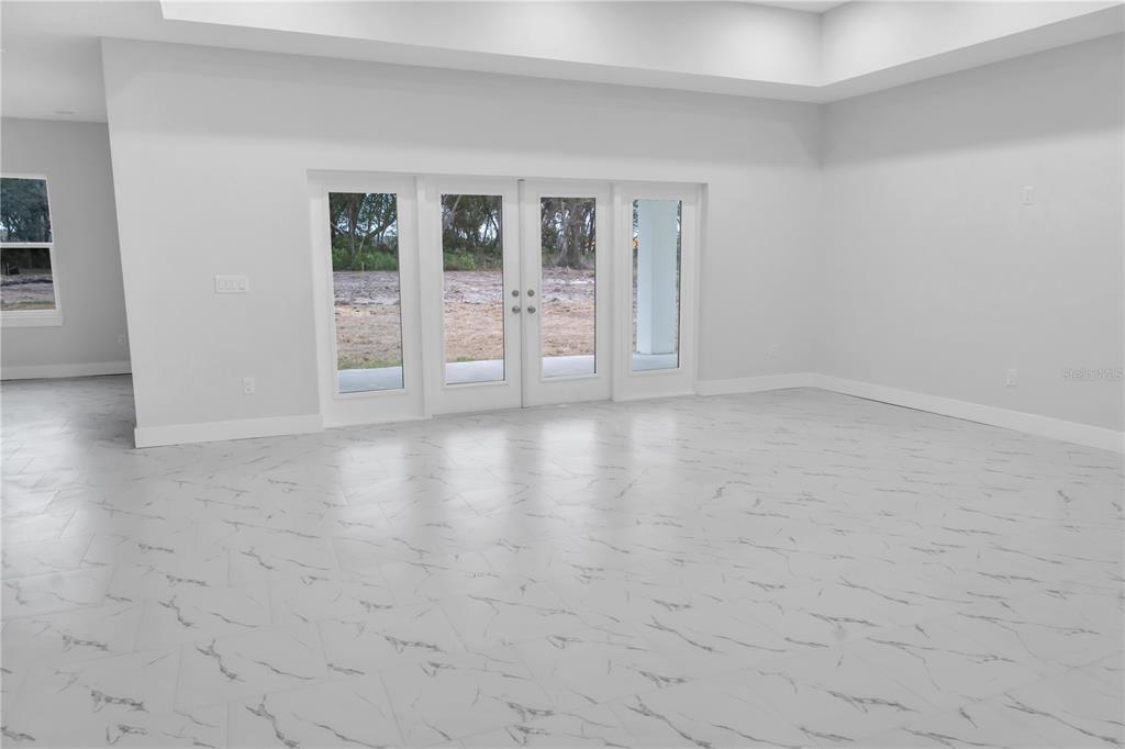 5530 Bell Street Zephyrhills, FL 33542 - Photo 12 of 16 a view of an empty room with glass door