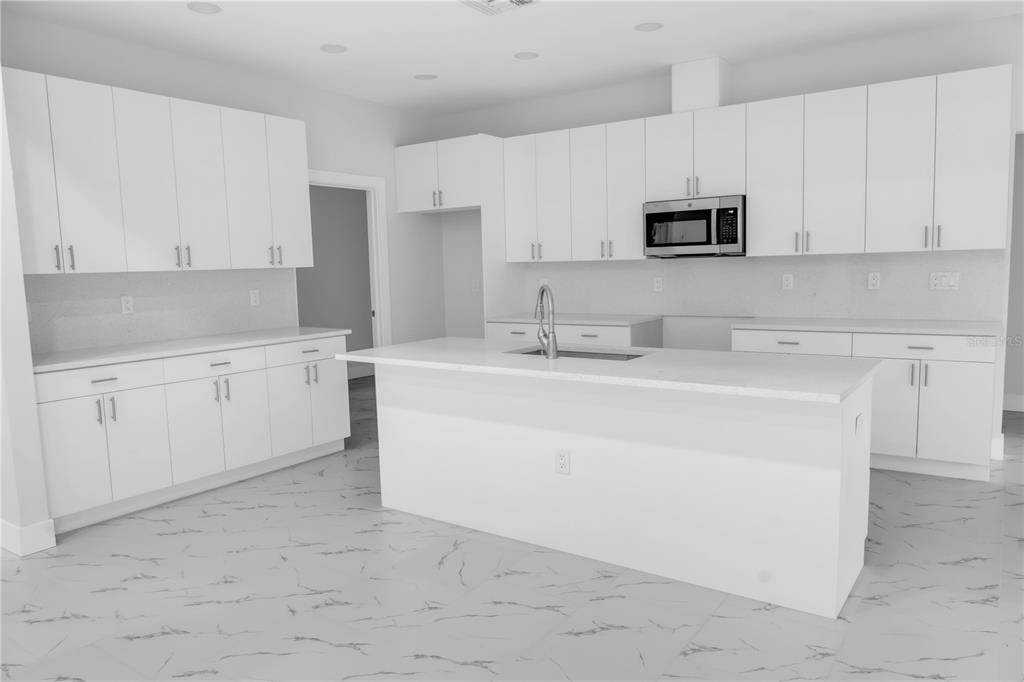 5530 Bell Street Zephyrhills, FL 33542 - Photo 4 of 16 a kitchen with appliances a sink and cabinets