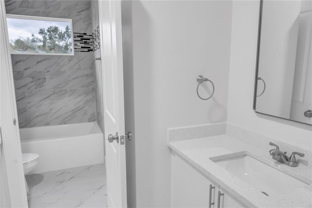 5530 Bell Street Zephyrhills, FL 33542 - Photo 6 of 16 a bathroom with a sink and a mirror