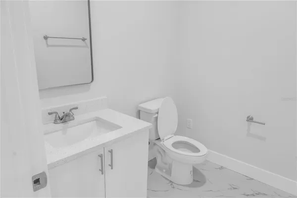 a bathroom with a sink a toilet and a mirror