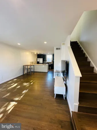 a view of kitchen and hall with wooden floor