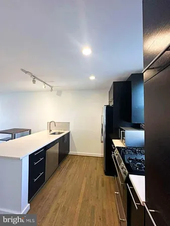 a large kitchen with a stove a sink and a refrigerator