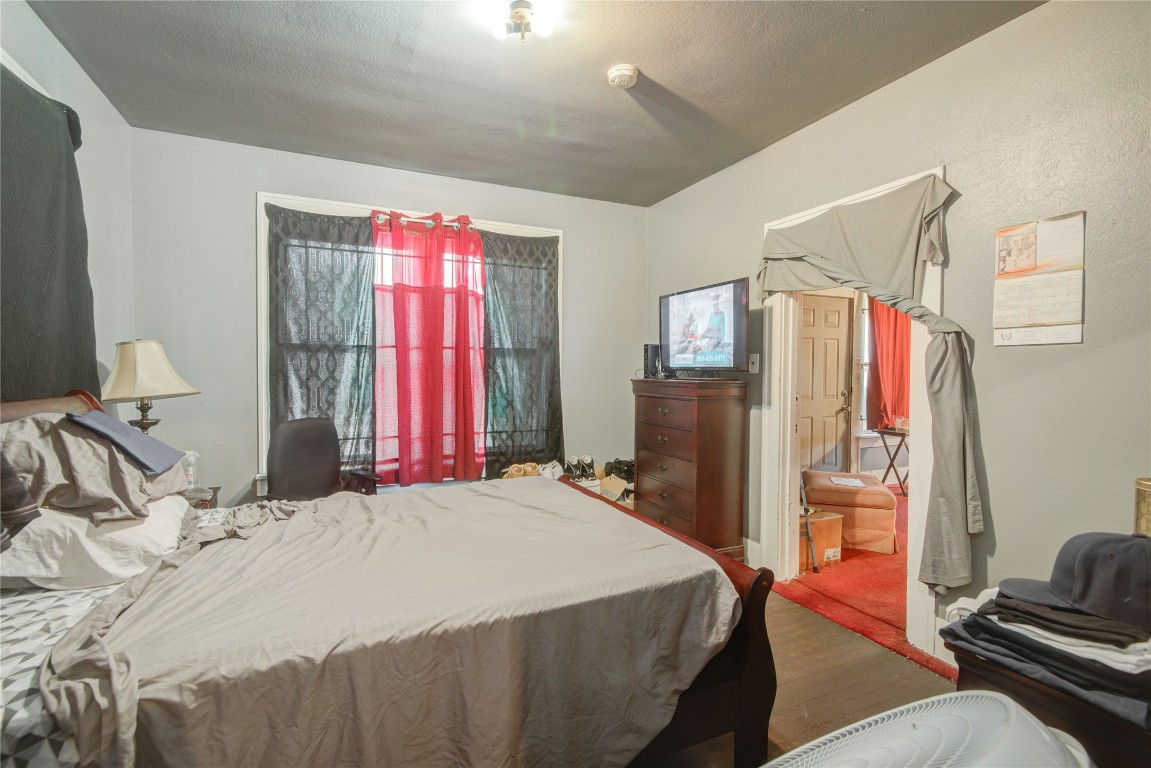 3405 Orange Street Houston, TX 77020 - Photo 9 of 19 a bedroom with a bed dresser and a window