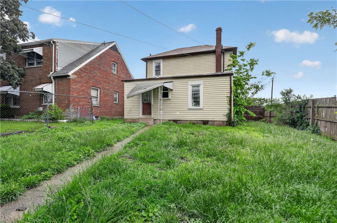 205 Rita Street Dayton, OH 45404 - Photo 27 of 34 This property features a charming exterior with a spacious yard, offering great outdoor potential.