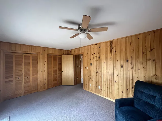 an empty room with closet and windows