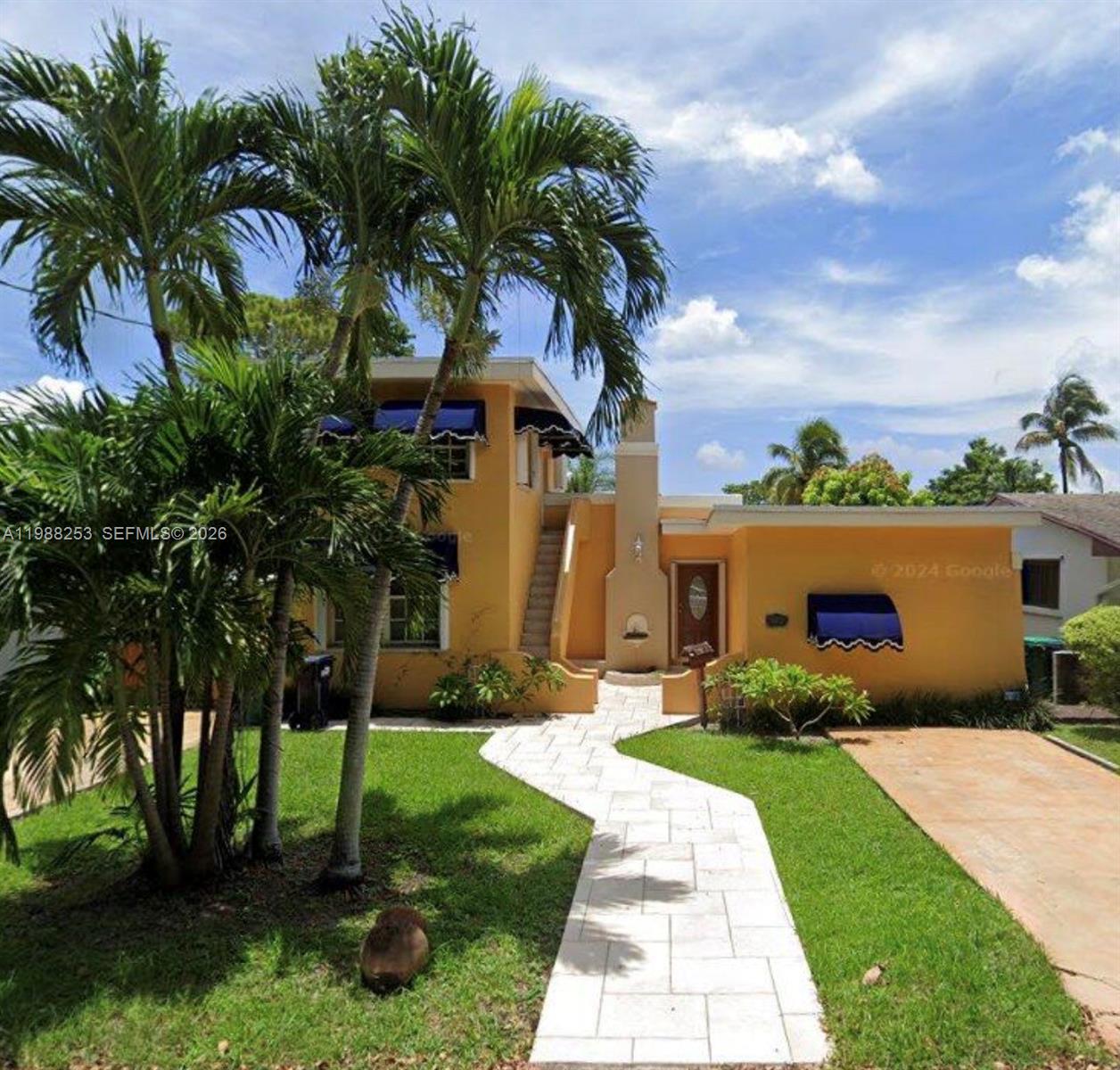 a front view of a house with garden
