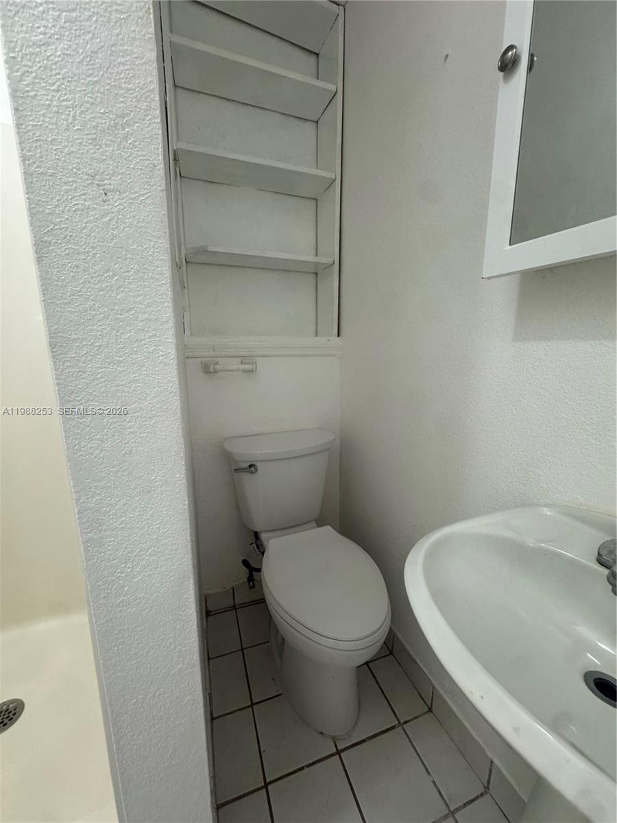 4472 Southwest 9th Lane, Unit 1 Miami, FL 33134 - Photo 10 of 10 a white toilet sitting next to a bath tub