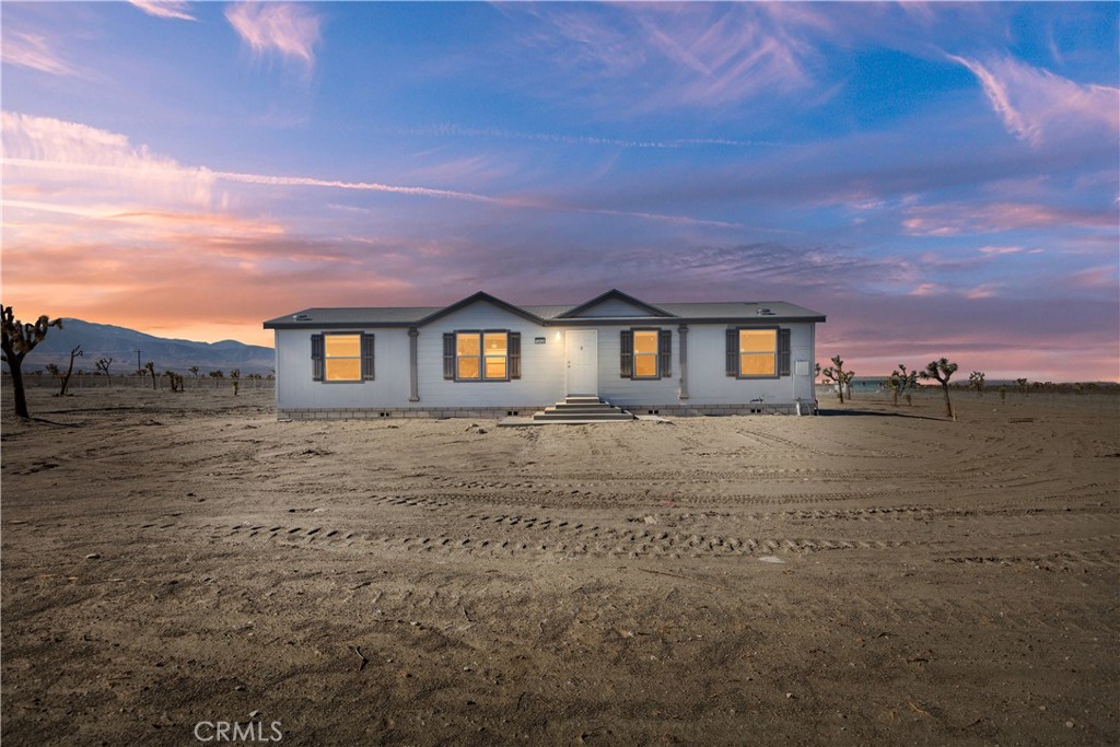 12426 Silver Rock Road Pinon Hills, CA 92372 - Photo 1 of 1 a front view of a house with a yard