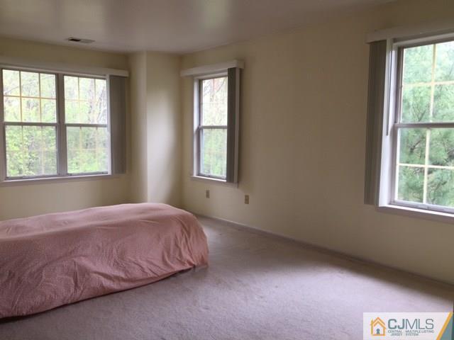 111 Raintree Court, Unit 111 Helmetta, NJ 08828 - Photo 7 of 11 a bedroom with a bed and a window