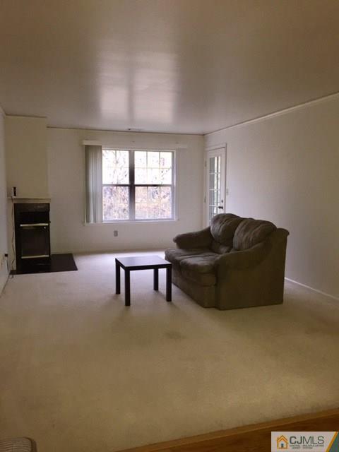 111 Raintree Court, Unit 111 Helmetta, NJ 08828 - Photo 10 of 11 a living room with furniture and a flat screen tv