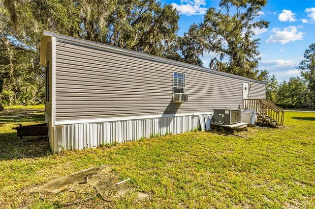 a backyard of a house with table and chairs