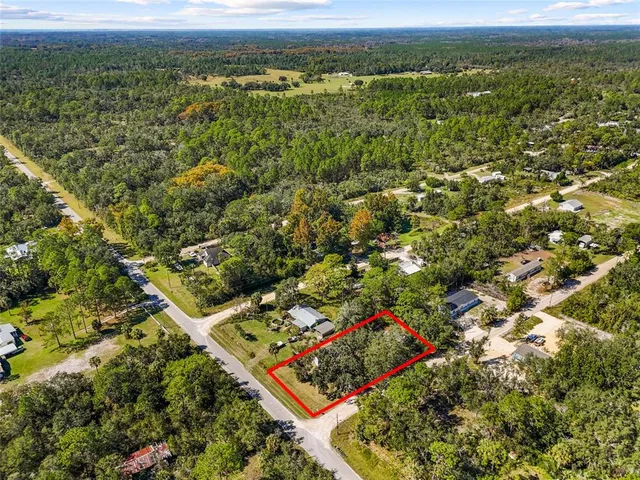 a backyard of a house with yard table and chairs