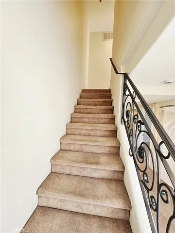 a view of a big room with windows and entryway