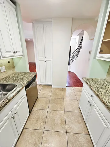 a kitchen with a stove top oven and cabinets