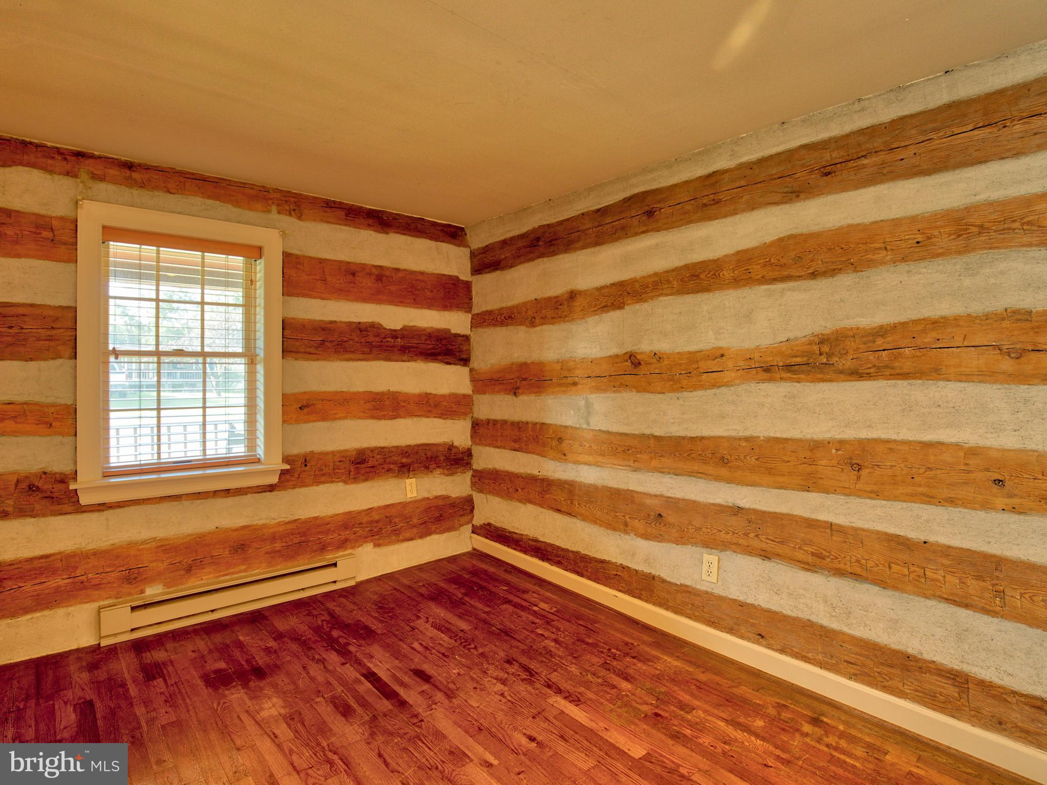 193 Giles Mill Road Bunker Hill, WV 25413 - Photo 23 of 29 a view of an empty room with wooden floor and a window