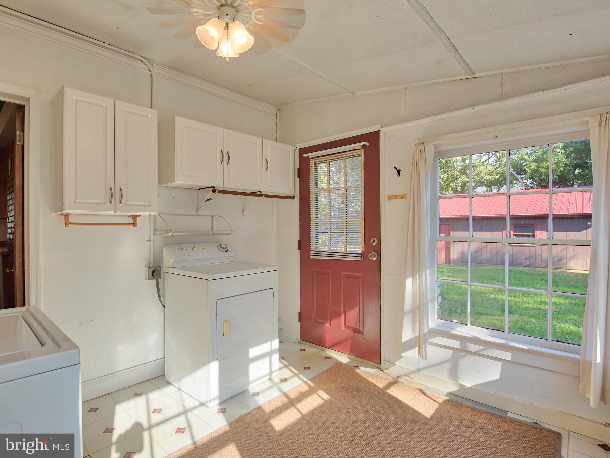 193 Giles Mill Road Bunker Hill, WV 25413 - Photo 25 of 29 a room with a bed and a chandelier