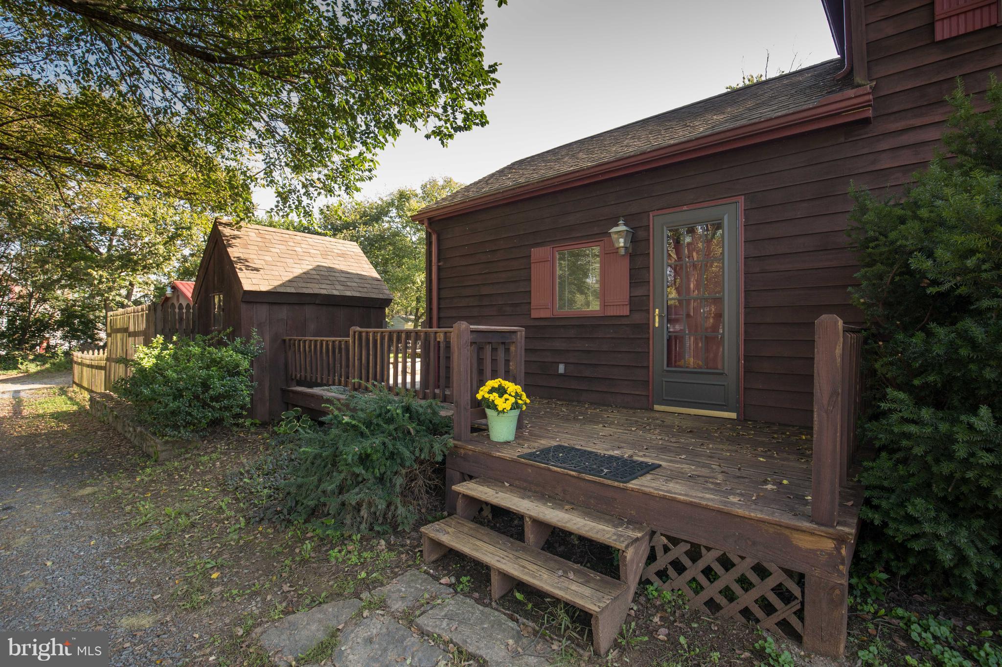 193 Giles Mill Road Bunker Hill, WV 25413 - Photo 5 of 29 a wooden bench sitting in front of a house