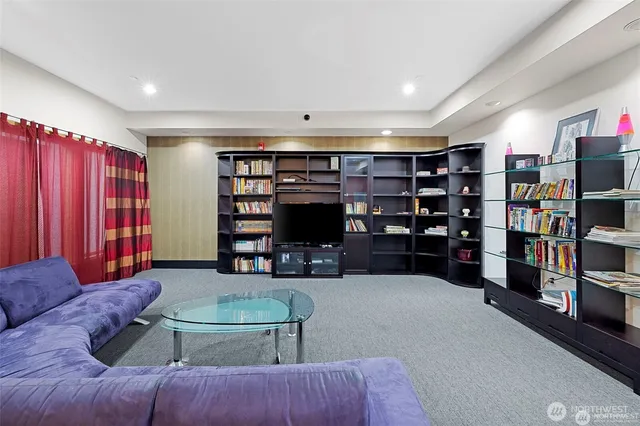 a living room with furniture and a book shelf