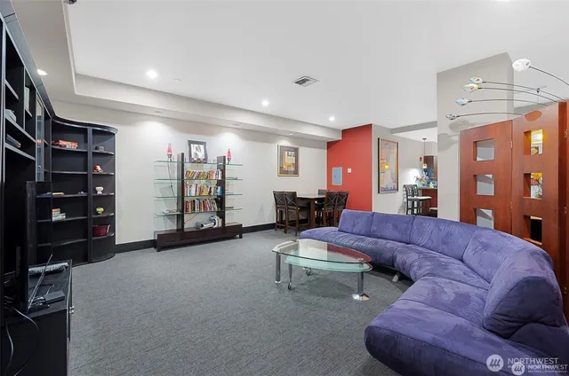 a living room with furniture and a walk in closet