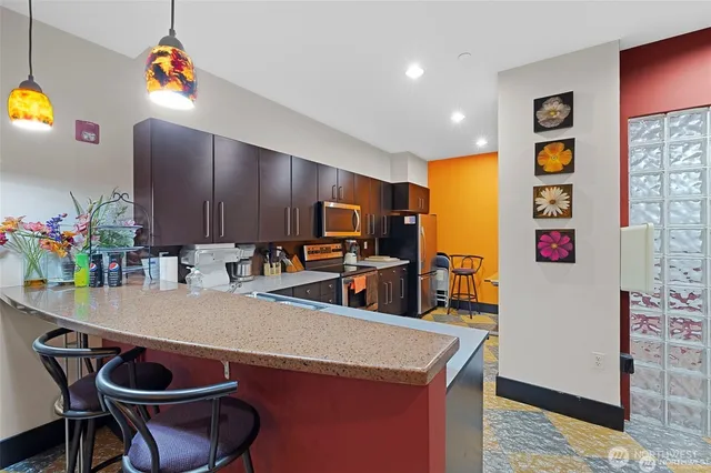 a kitchen with stainless steel appliances a stove a refrigerator and a microwave