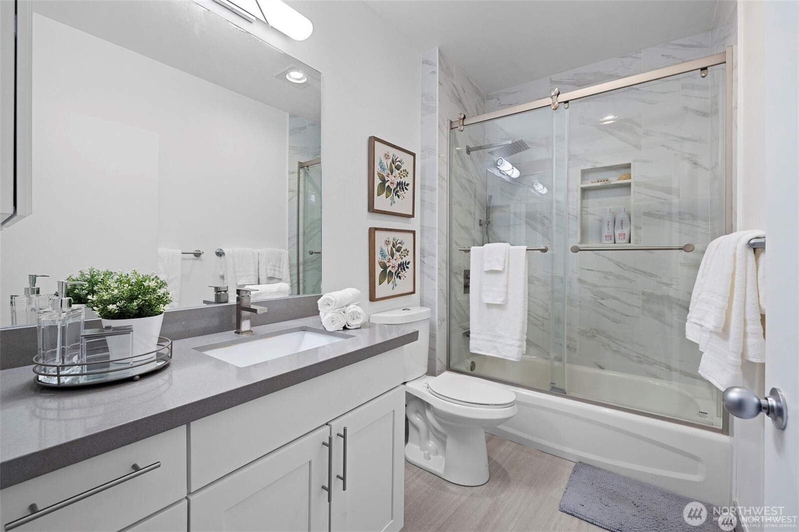 668 South Lane Street, Unit 603 Seattle, WA 98104 - Photo 2 of 22 a bathroom with a granite countertop sink a toilet and shower
