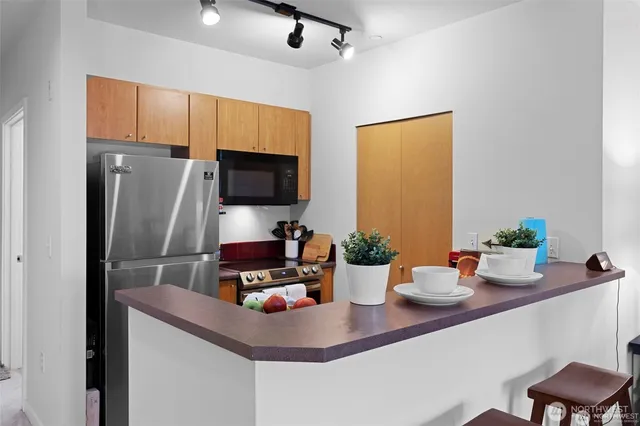 a kitchen with a sink a counter space and stainless steel appliances