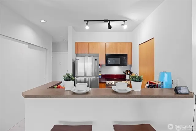 a kitchen with a sink appliances and cabinets