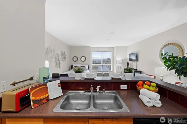 a living room with furniture and potted plants