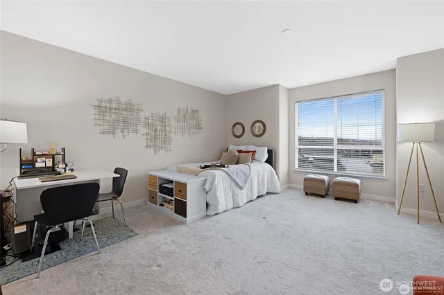 a bedroom with furniture and a large window