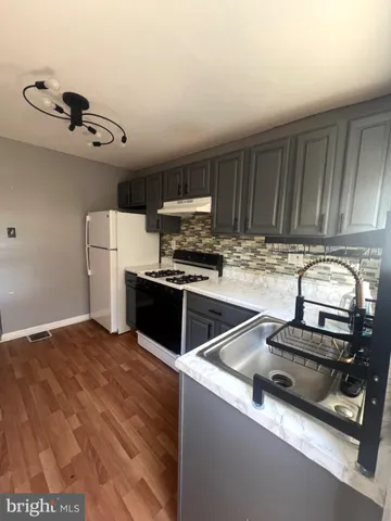 a kitchen with a sink stainless steel appliances and cabinets