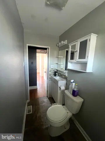 a bathroom with a toilet sink and mirror