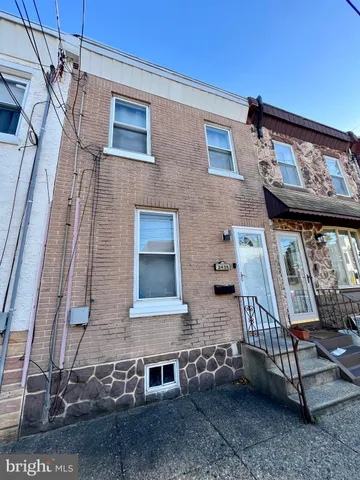 a view of a brick house with many windows