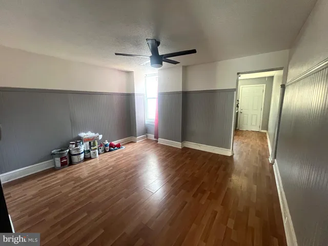 a view of a room with wooden floor