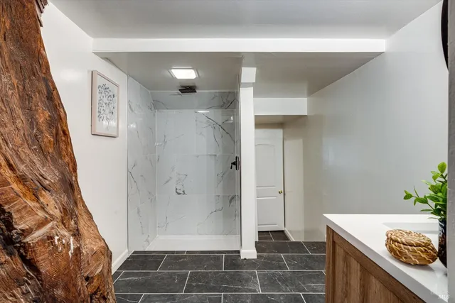 a bathroom with a shower and a sink