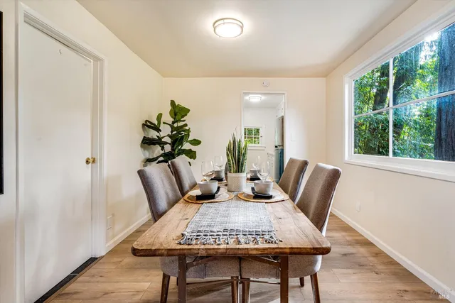 a view of a dining room with furniture window and wooden floor