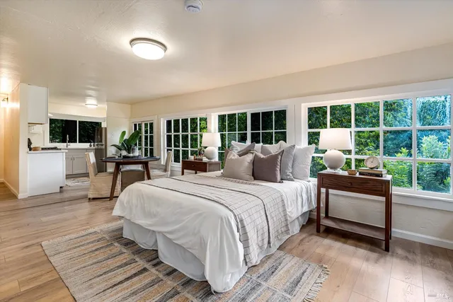 a spacious bedroom with a large bed and a large window