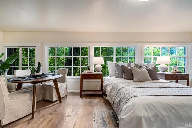 a bedroom with furniture and a large window