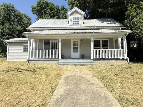 a view of house with backyard and deck