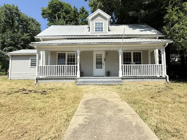 a view of house with backyard and deck