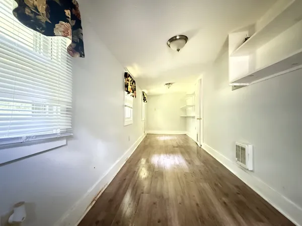 a view of hallway with wooden floor