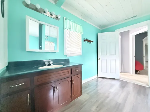 a kitchen with sink and cabinets