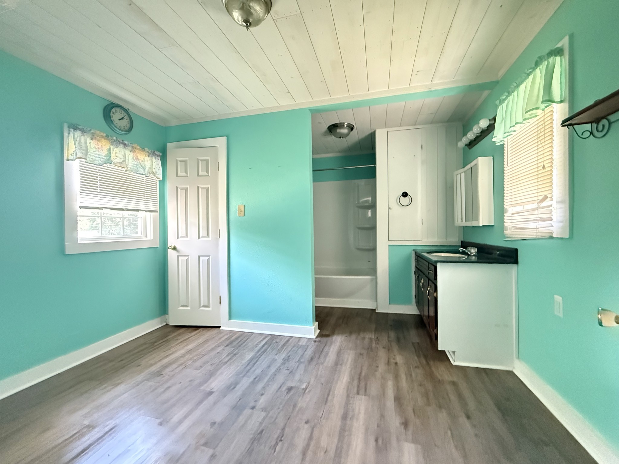 2844 Jarman Hollow Road Palmyra, TN 37142 - Photo 20 of 32 a view of a kitchen with a fridge wooden floor and a window