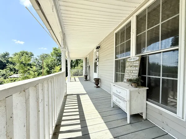 a balcony with furniture and wooden floor