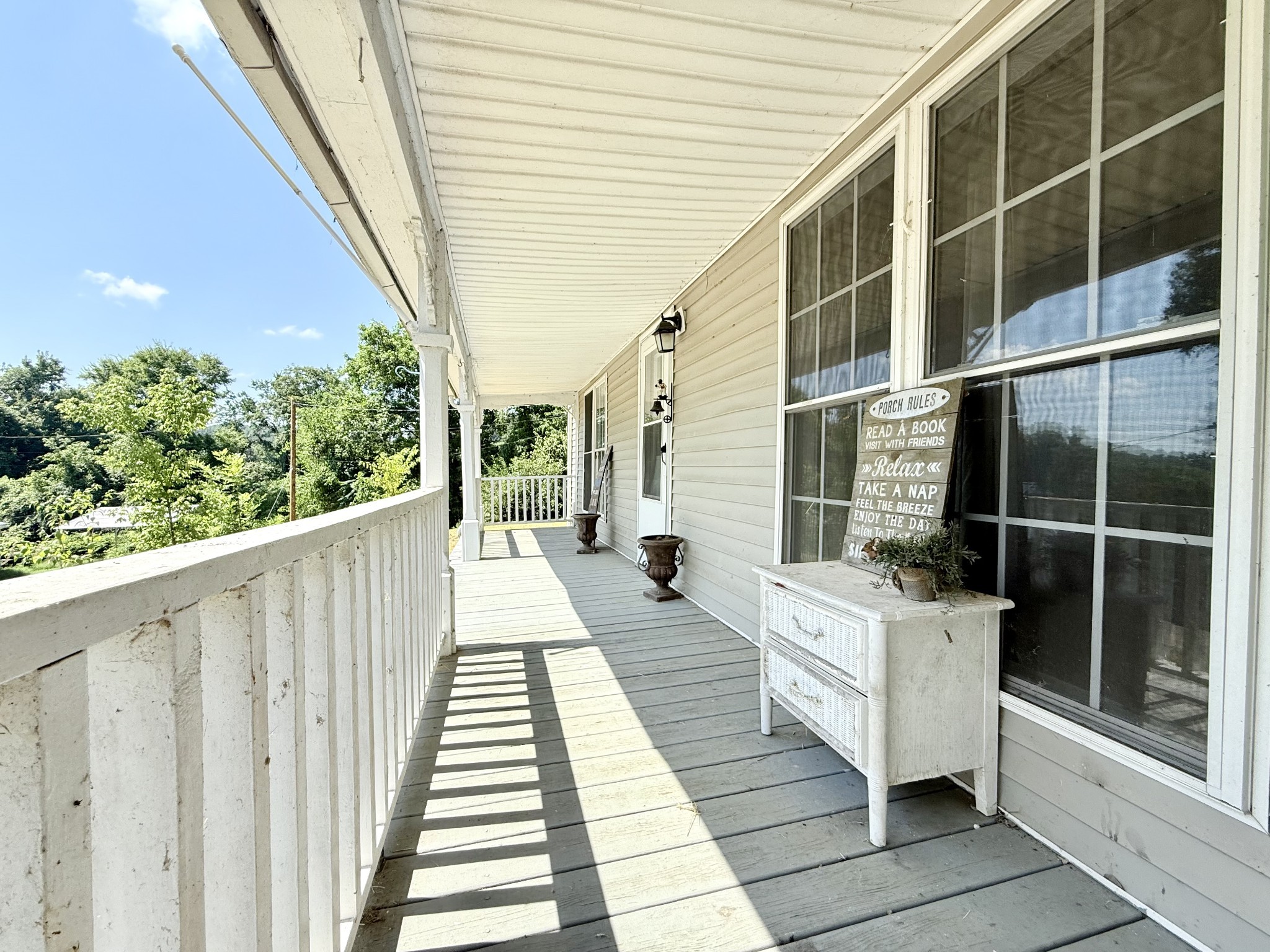 2844 Jarman Hollow Road Palmyra, TN 37142 - Photo 2 of 32 a balcony with furniture and wooden floor